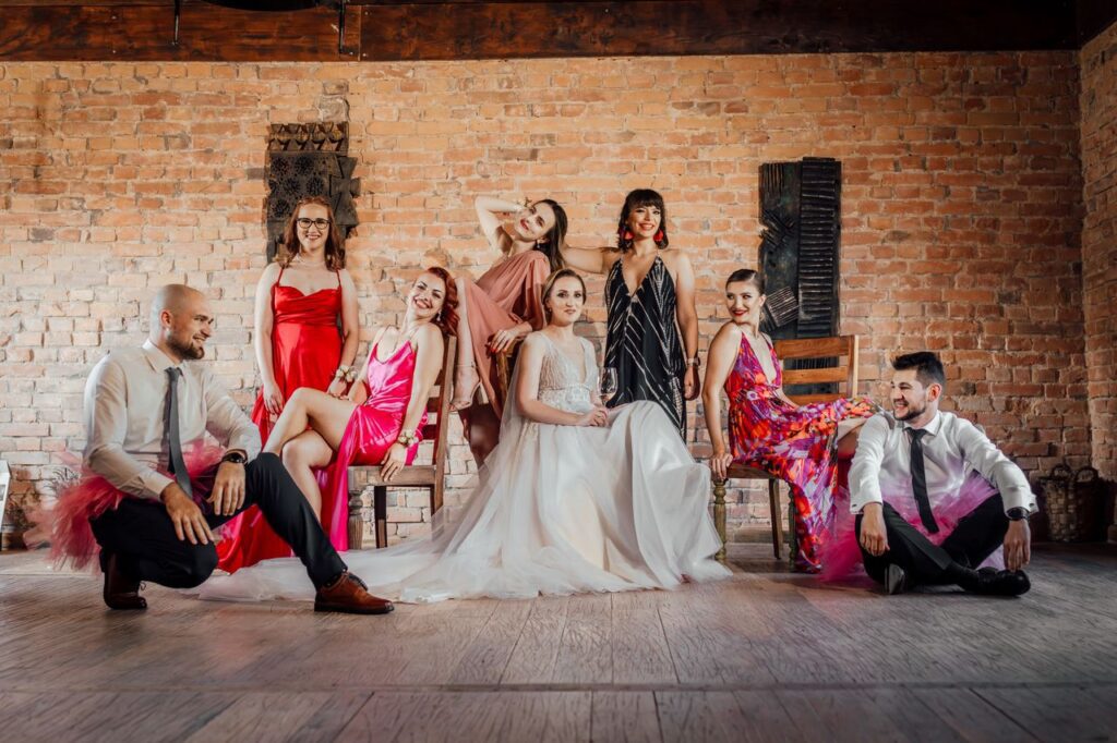 A fun and stylish bridal party photo with friends and vibrant fashion indoors.