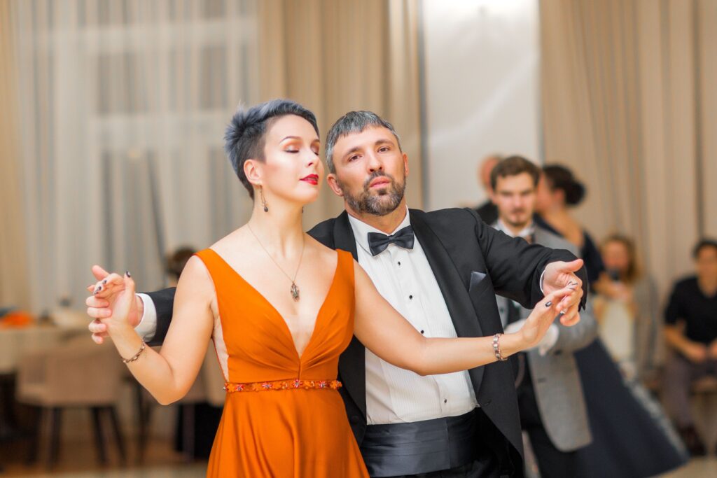 A couple performs a graceful dance at a wedding reception, showcasing elegance and style.